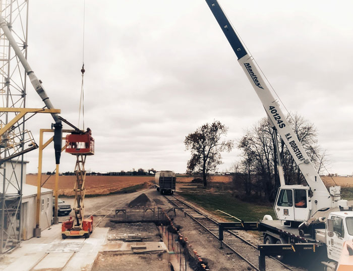 Crane lifting heavy construction pieces into place.