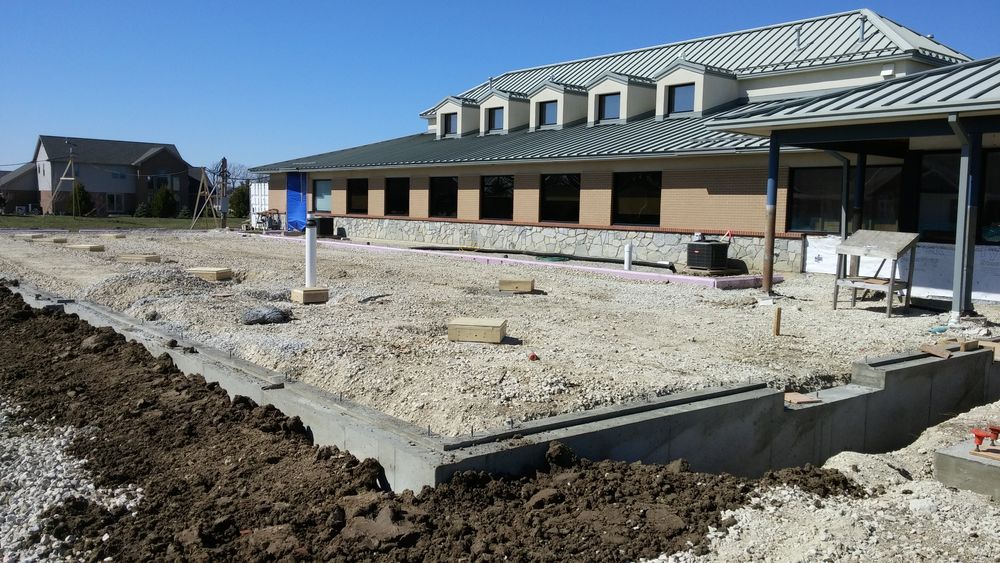 Foundation and gravel base for addition to existing dental clinic.