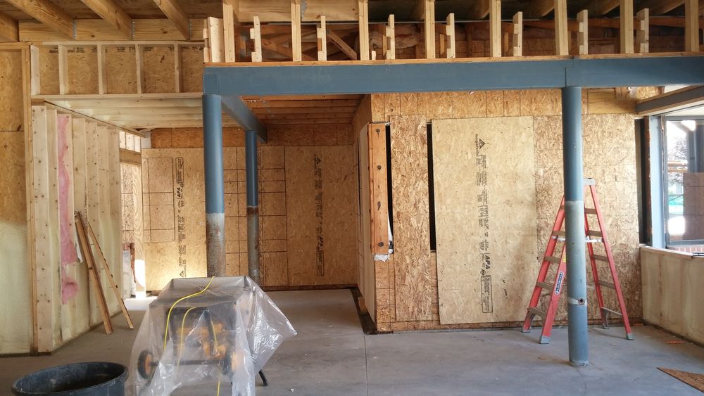 Interior wood and steel framing ongoing for new addition to existing dental clinic.
