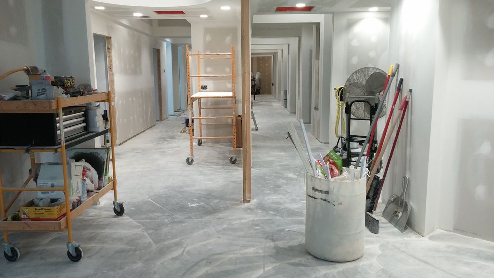 Drywall ongoing in new addition to existing dental clinic.