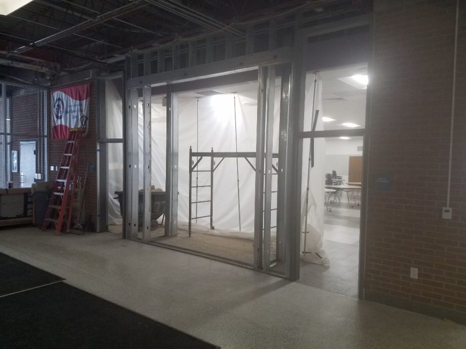 Construction ongoing for new display case by front entrance.