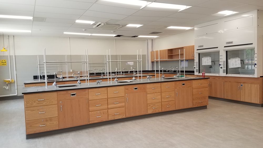 New casework and fume hoods in science room.