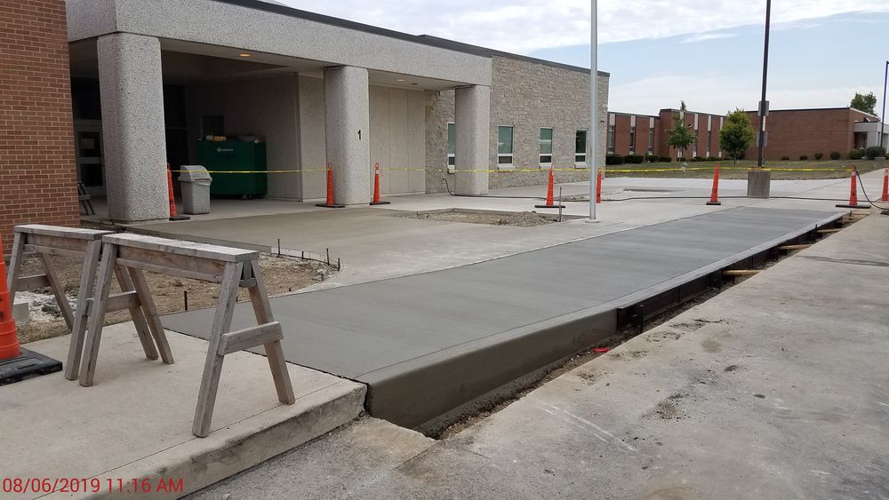 Fresh concrete just placed in front of school.