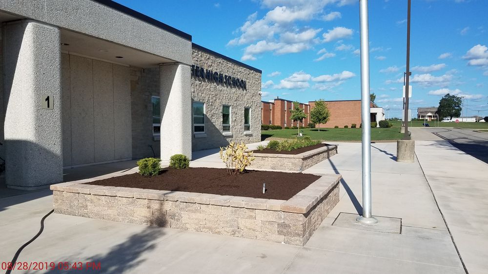 New raised landscape beds in front of school.