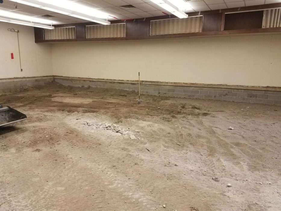 Concrete floor in band room full removed.