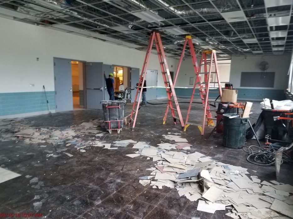 Removal of old flooring in cafeteria.