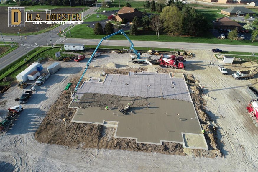 Aerial view of concrete building slab being poured.