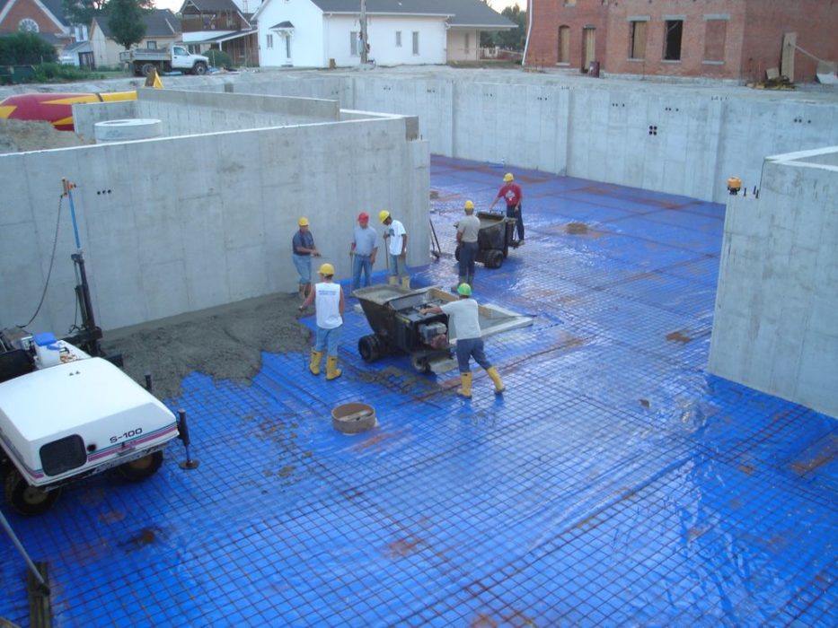 Pouring concrete floor for basement.