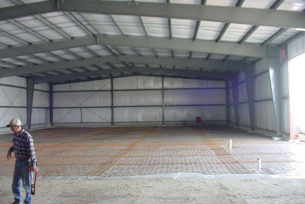 View of the inside of a custom-engineered metal building without concrete floor poured.